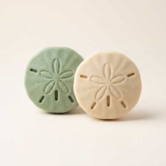 Two handmade sand dollar shaped soap bars from the Coastal Calm collection
