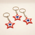 Set of three 3D printed star keychains in red, white, and blue