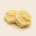 Honeycomb-pressed beeswax and honey soap bar with a bee detail